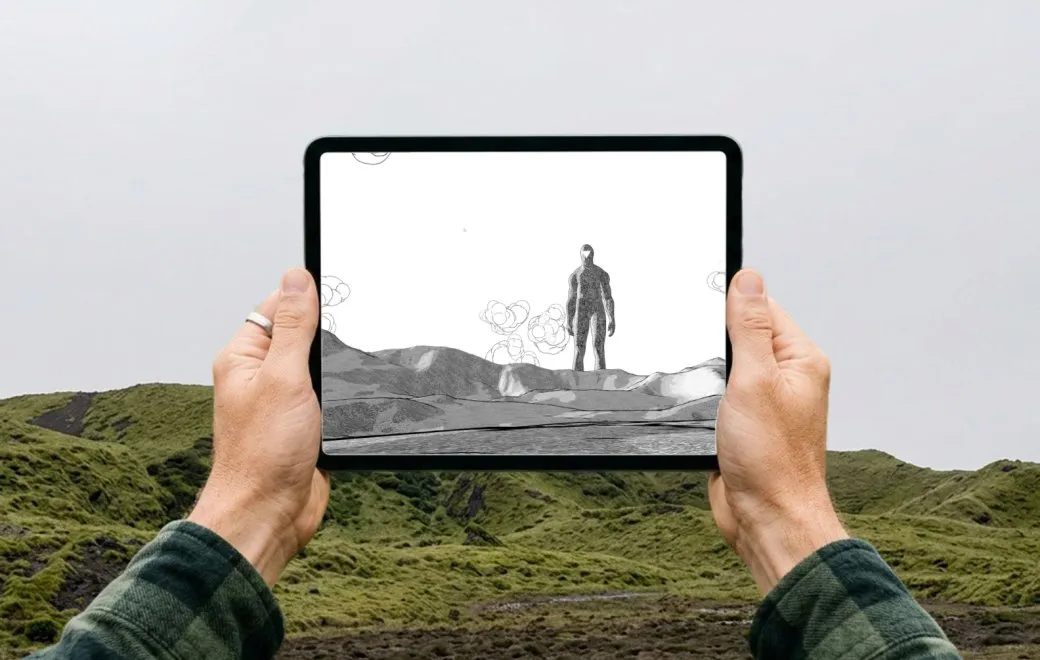 Une tablette affiche l'univers dessiné de Légende des Cimes devant un paysage de montagne